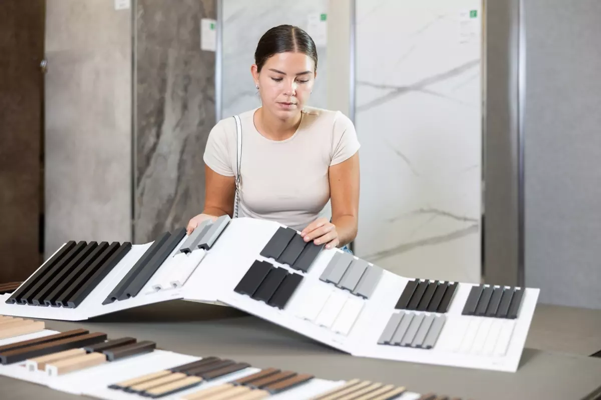 A woman evaluating siding options