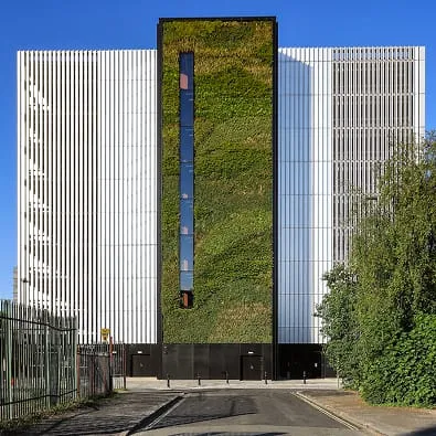 Ancoats building with living green wall between white architectural panels