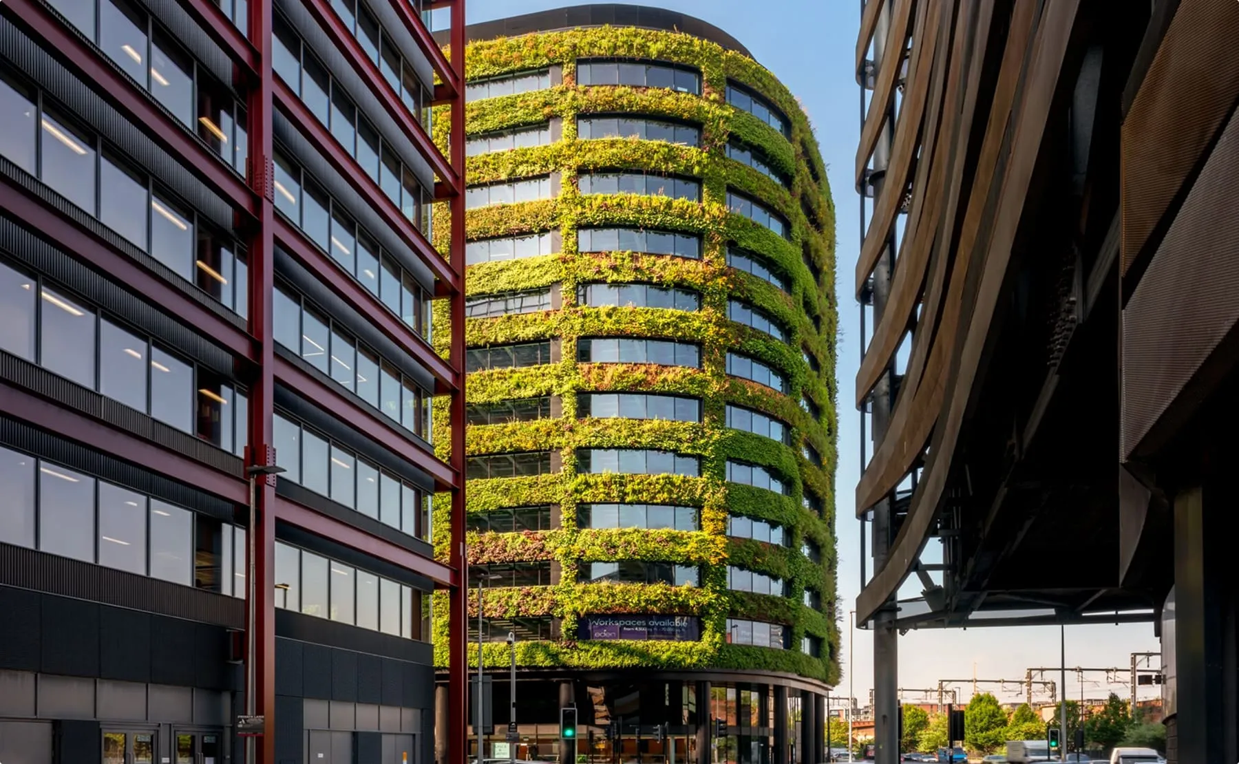 Curved living wall covers modern office building  Eden with lush green vegetation