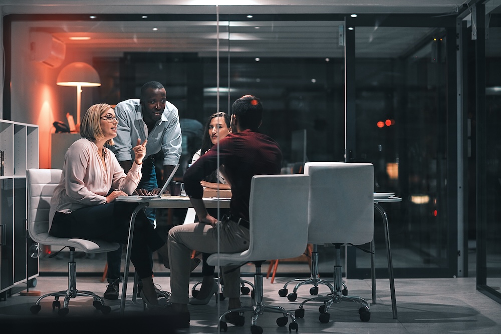 Business meeting with focused professionals discussing insurance placement strategy