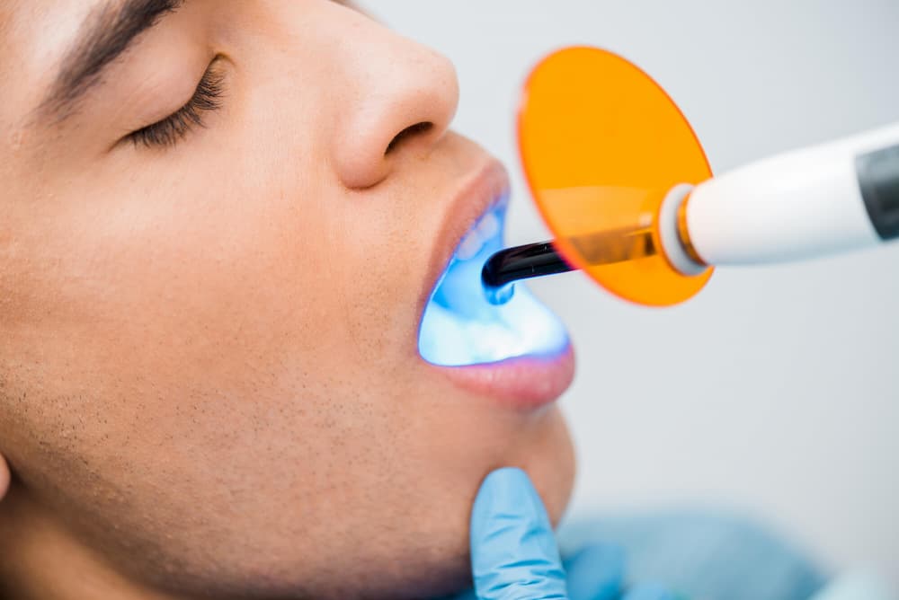 photo of a young male patient receiving dental treatment