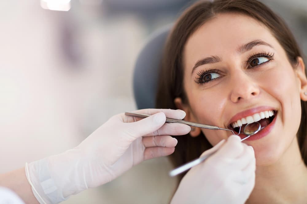 photo of a smiling female patient at the dentist