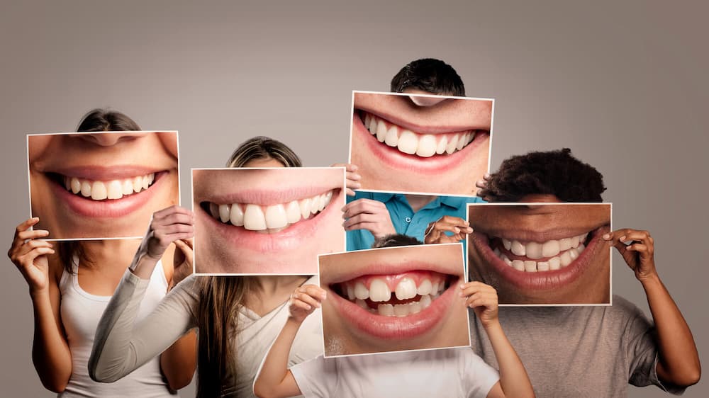 photo of a family holding up photos of their big smiles
