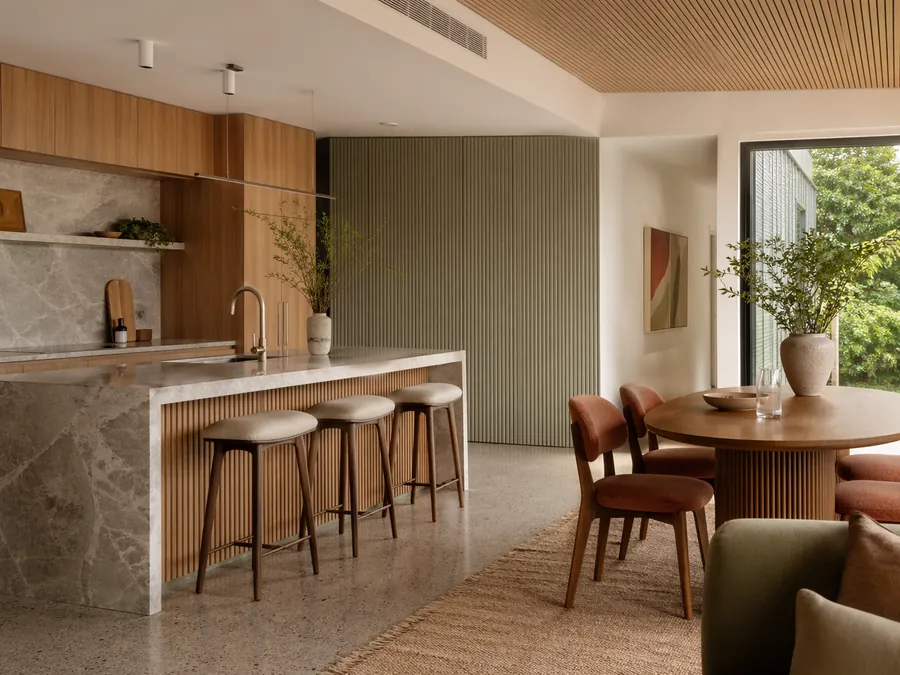 Kitchen and dining area with hard surfaces and acoustic design for reduced echo and improved comfort.