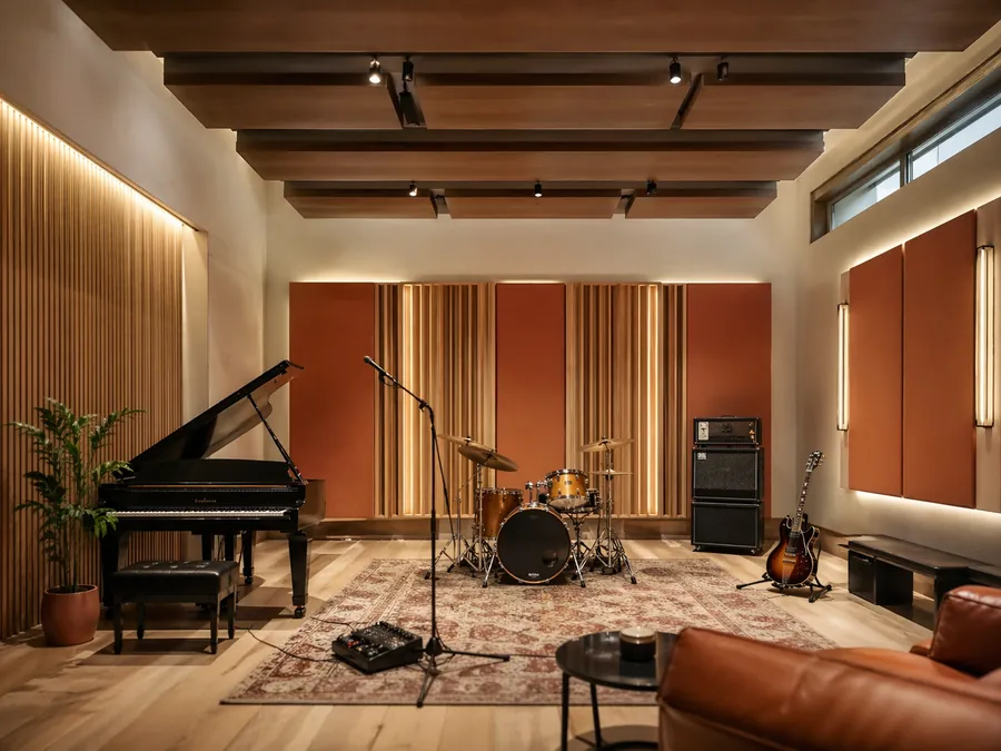 Music practice room acoustic design with instruments, timber finishes and integrated acoustic treatment.