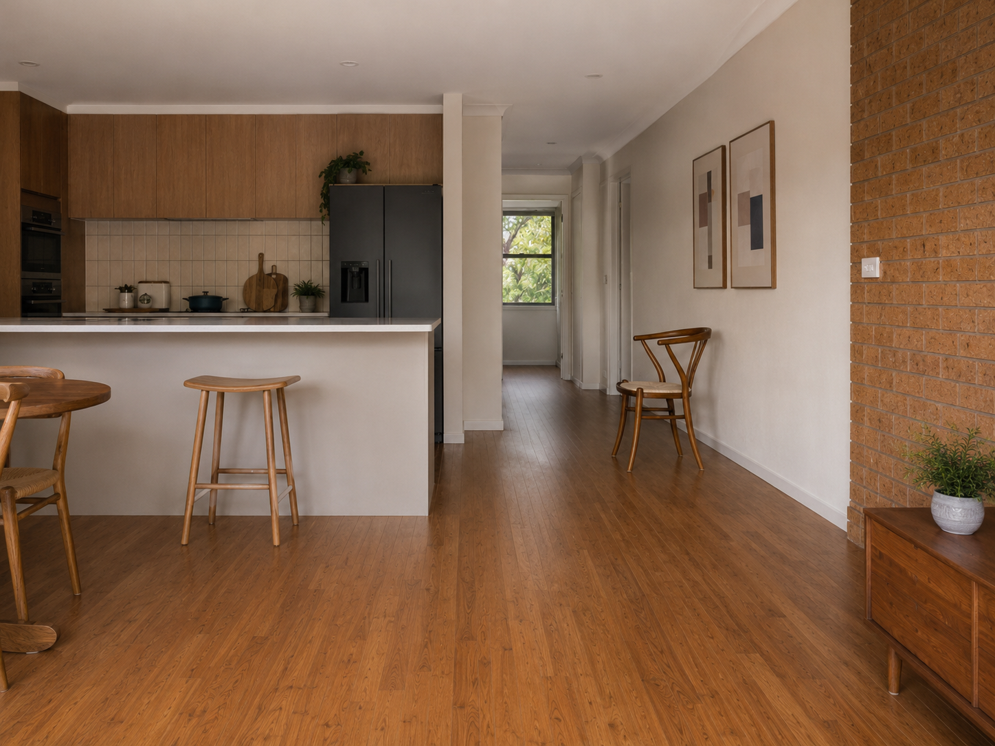 Kitchen and hallway zone in an older apartment showing masonry wall, tiled and timber-look flooring and likely flanking transmission context.