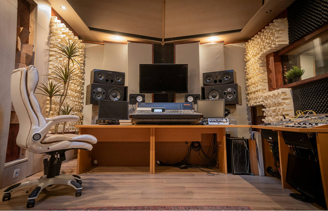 Recording studio room with mixing desk, monitors and timber acoustic treatment