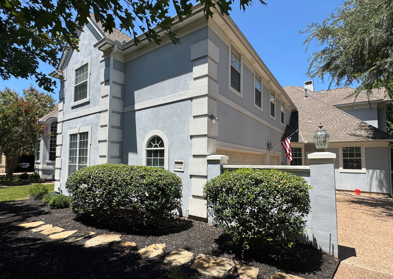 Two-story home exterior with driveway and landscaping in Fort Worth, TX