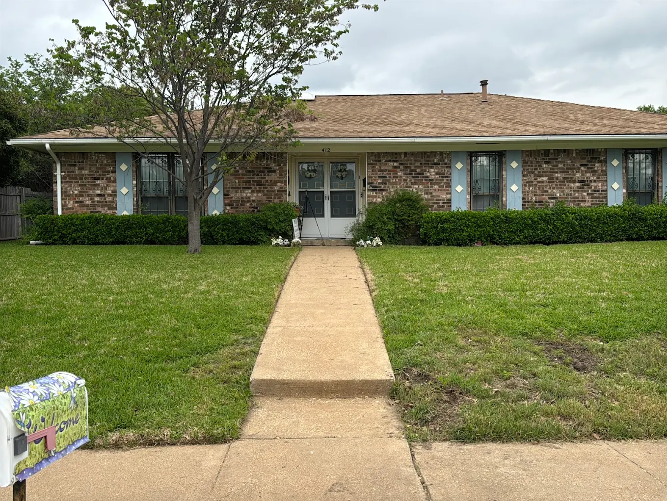 Single-story brick duplex front with walkway and lawn in Fort Worth, TX