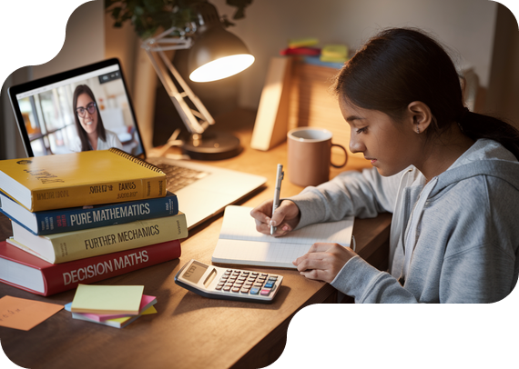 Student studying A-Level Further Math with textbooks and online tutor
