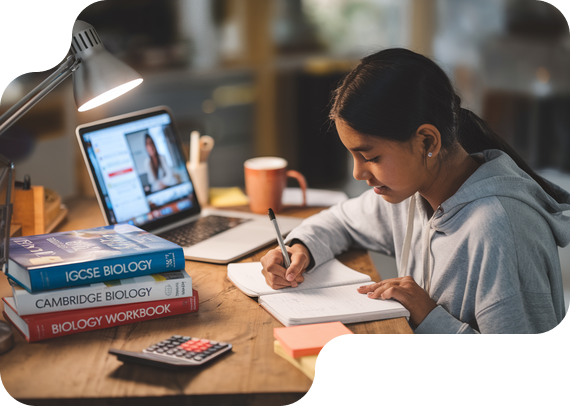 Student studying IGCSE Biology with textbooks and online tutor
