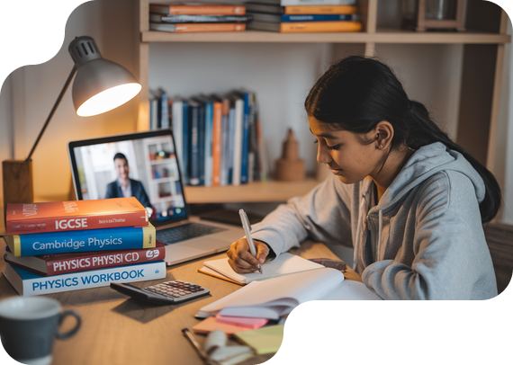 Student studying IGCSE Physics with textbooks and online tutor