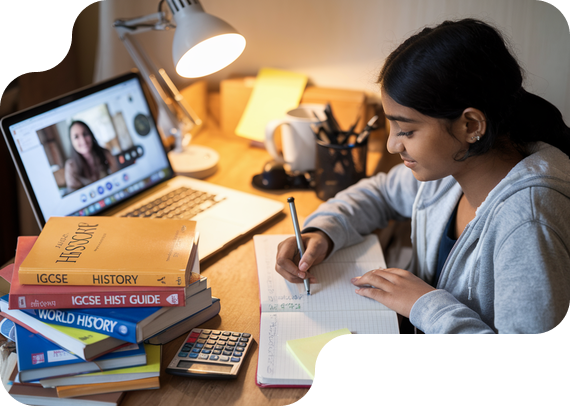 Student studying IGCSE History with textbooks and online tutor