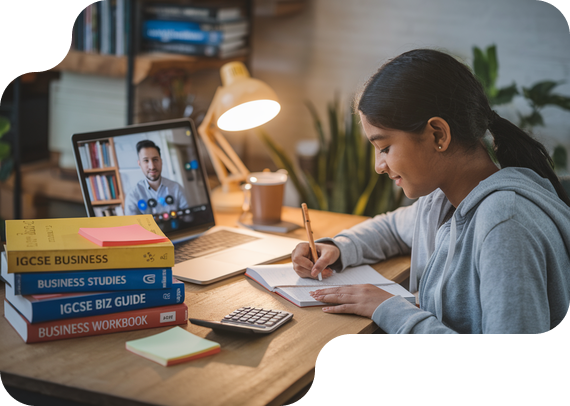 Student studying IGCSE Business with textbooks and online tutor