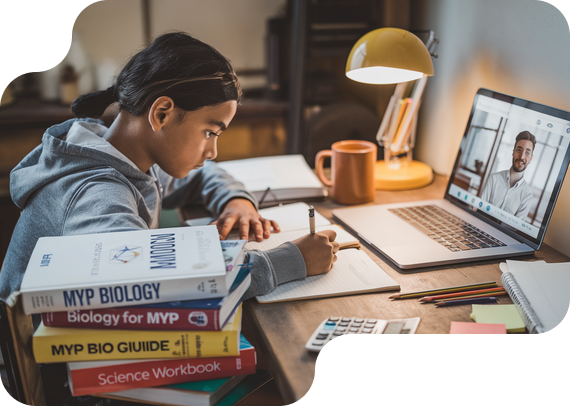 Student studying MYP Biology with textbooks and online tutor