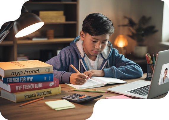 Student studying MYP French with textbooks and online tutor