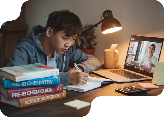Student studying Pre-IB Chemistry with textbooks and online tutor
