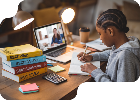 Student preparing for SSAT exam with prep books and online tutor