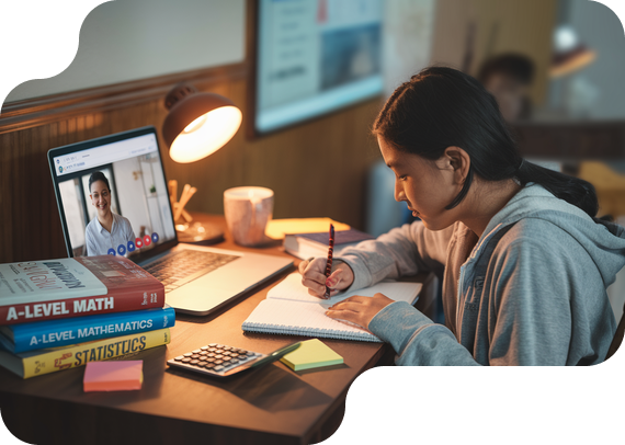Student studying A-Level Math with textbooks and online tutor
