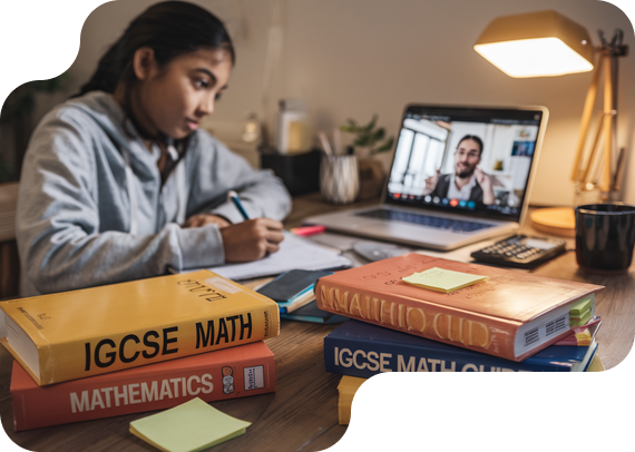 Student studying IGCSE Math with textbooks and online tutor