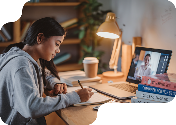 Student studying IGCSE Combined Sciences with textbooks and online tutor