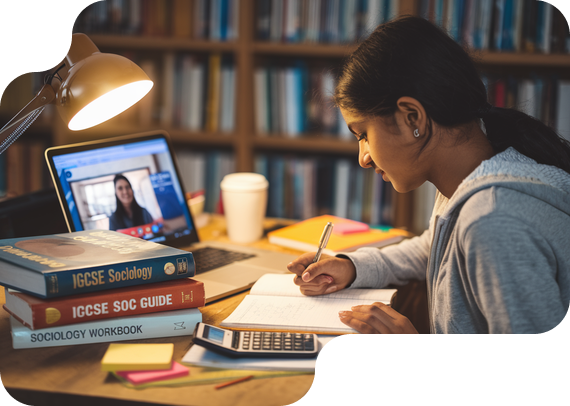 Student studying IGCSE Sociology with textbooks and online tutor
