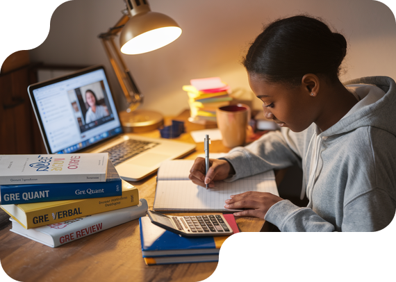 Student preparing for GRE exam with prep books and online tutor