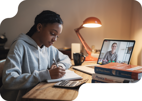 Student studying US Physics Honors with textbooks and online tutor