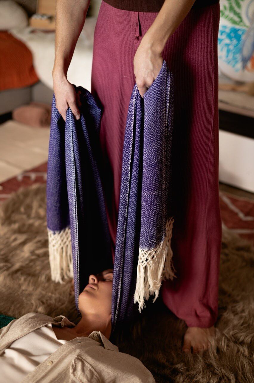 Rebozo cloth cradling the head during a session