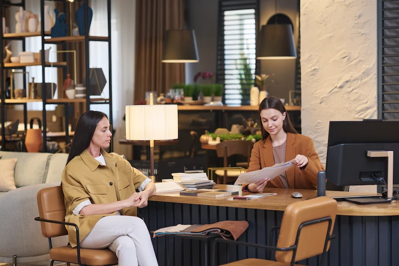 young women sitting at desk in furniture