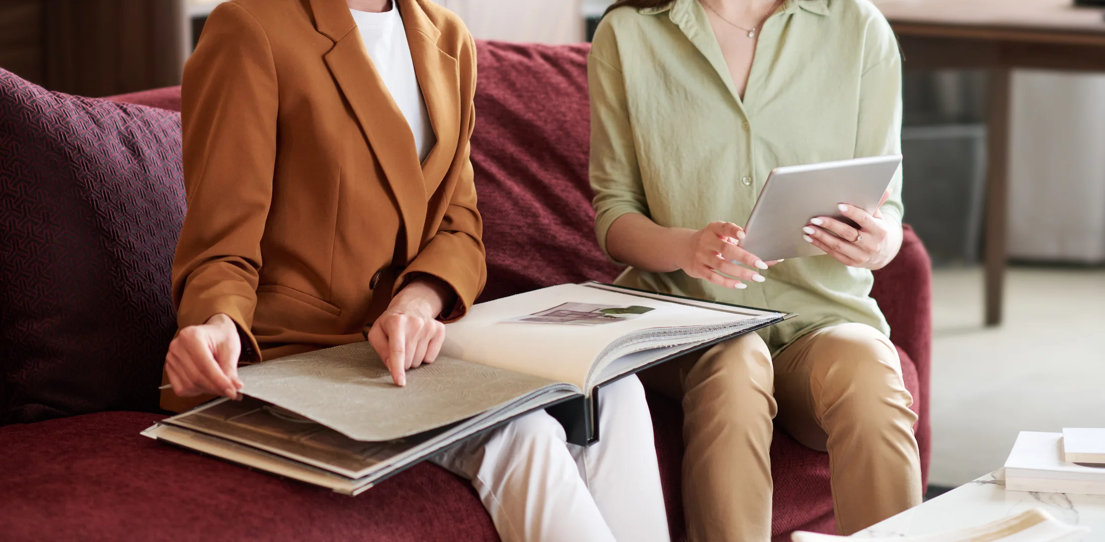 young women smiling looking at financing in furniture store