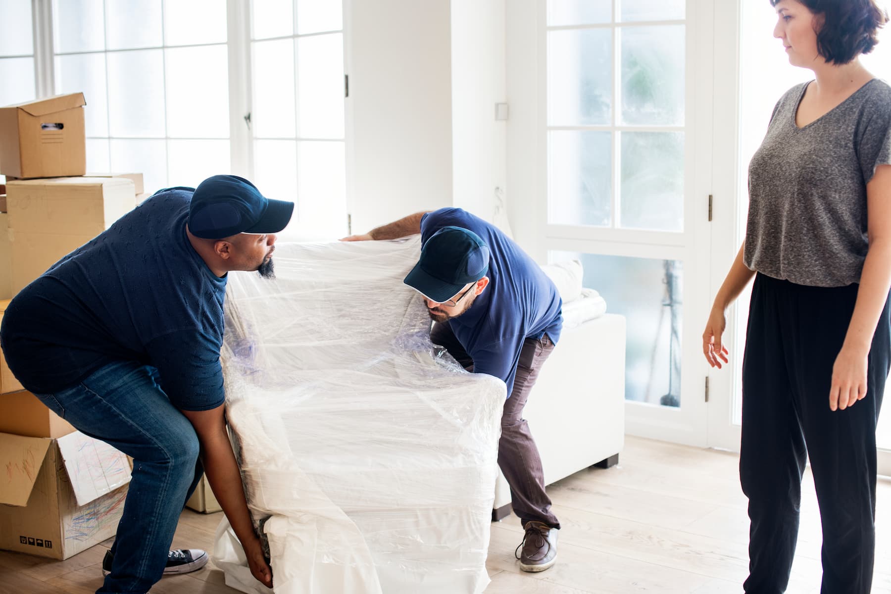 couple moving furniture into new home