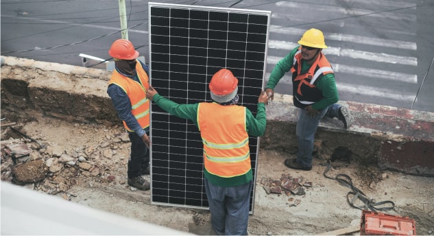 a group of men working on a solar panel