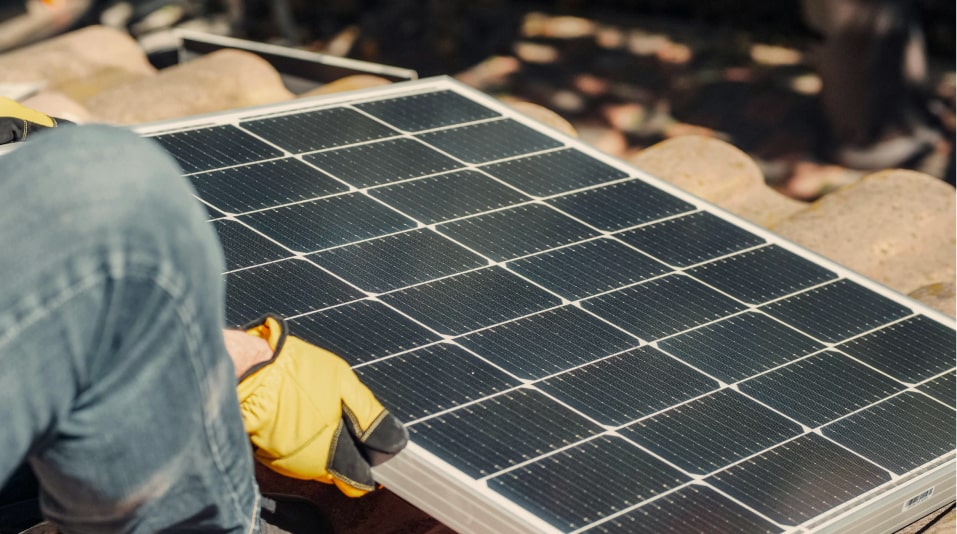 a person holding a solar panel