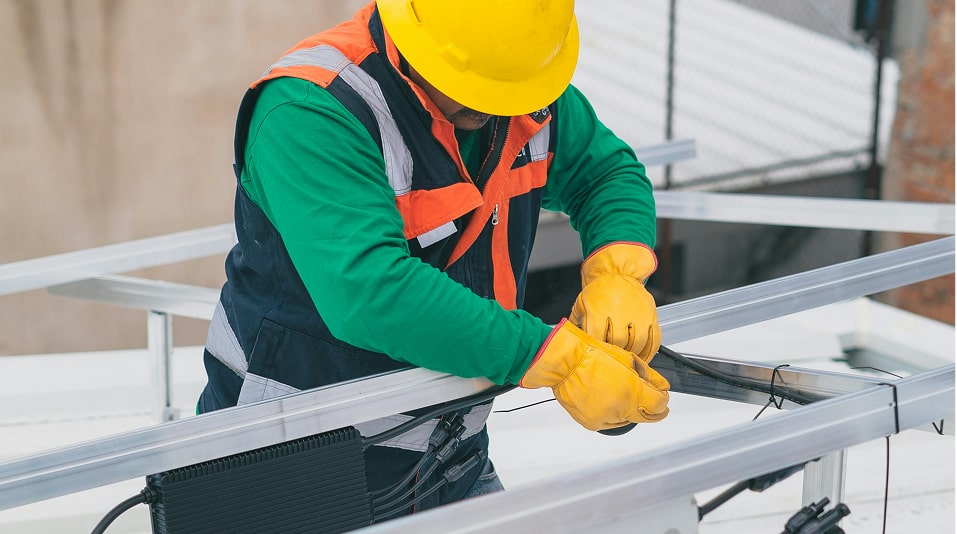 a man wearing a hard hat and gloves