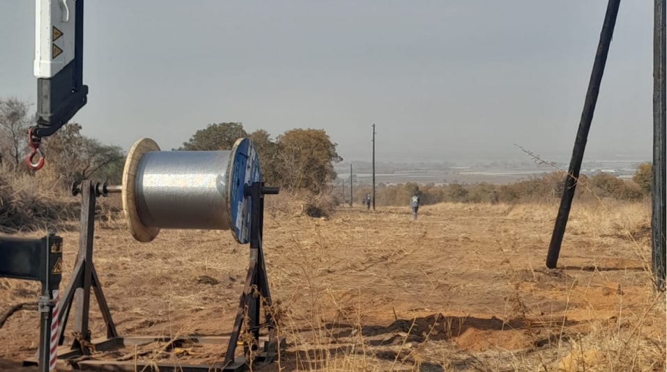 a large spool of wire in a field