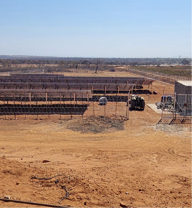 a large field with a large solar panel