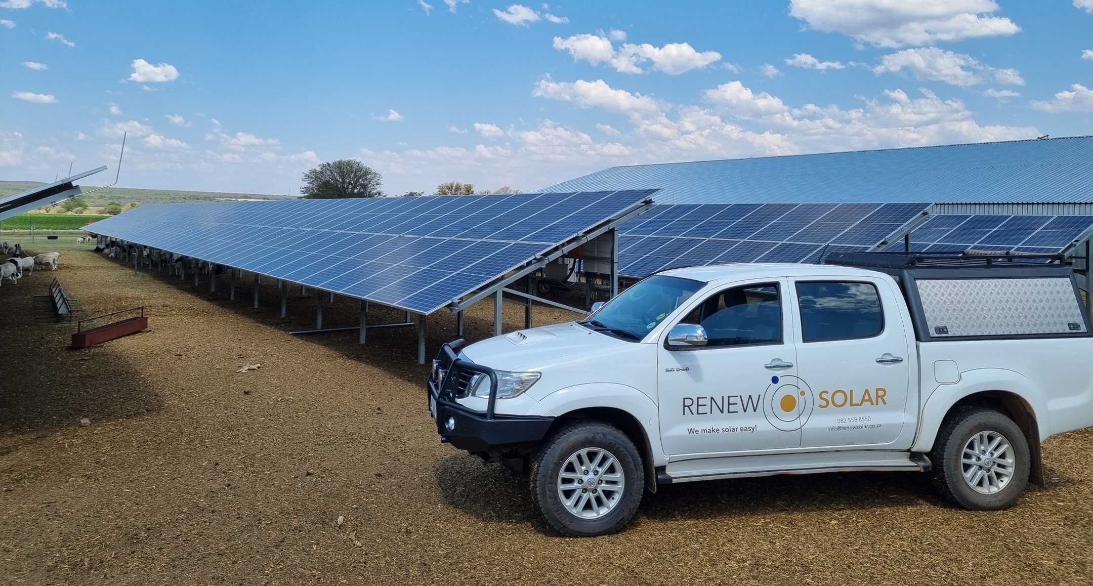 a car parked next to solar panels