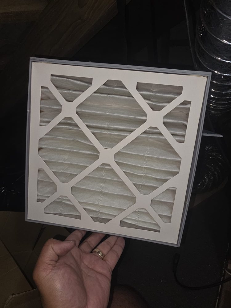 Clean new HRV filter held up in a roof space
