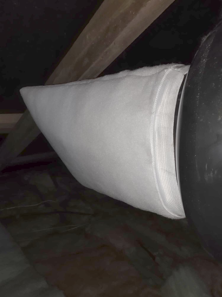 Clean new white DVS filter fitted in a roof space