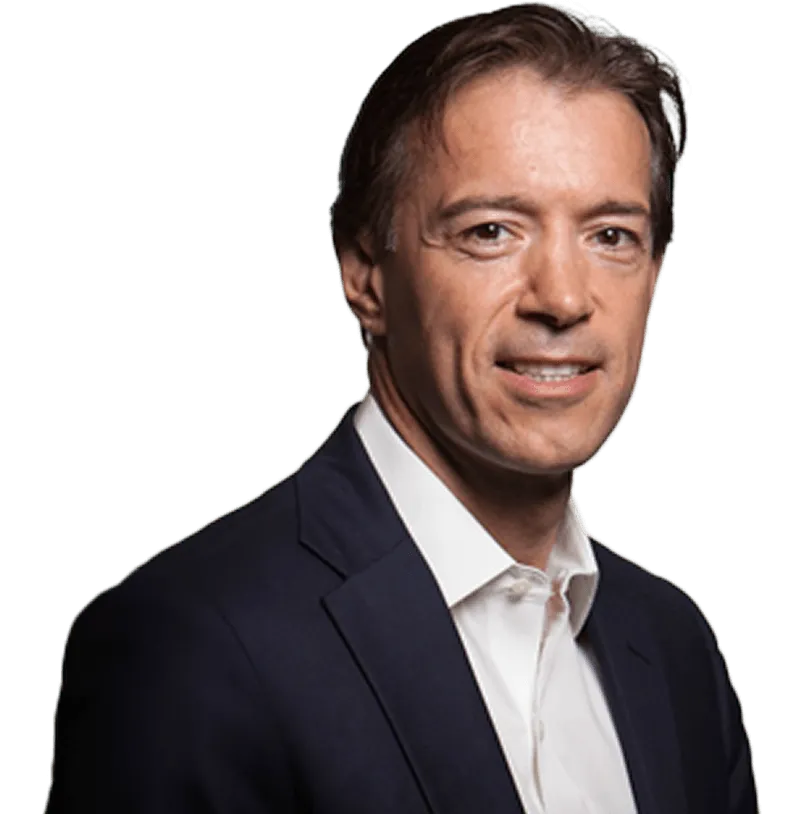 A man in a suit is smiling for the camera.