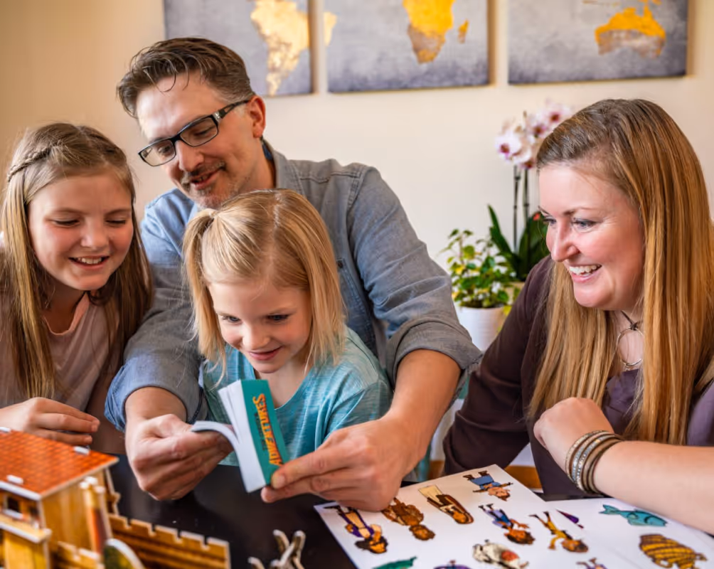Family smiling while playing with The Chosen Adventures activity kit