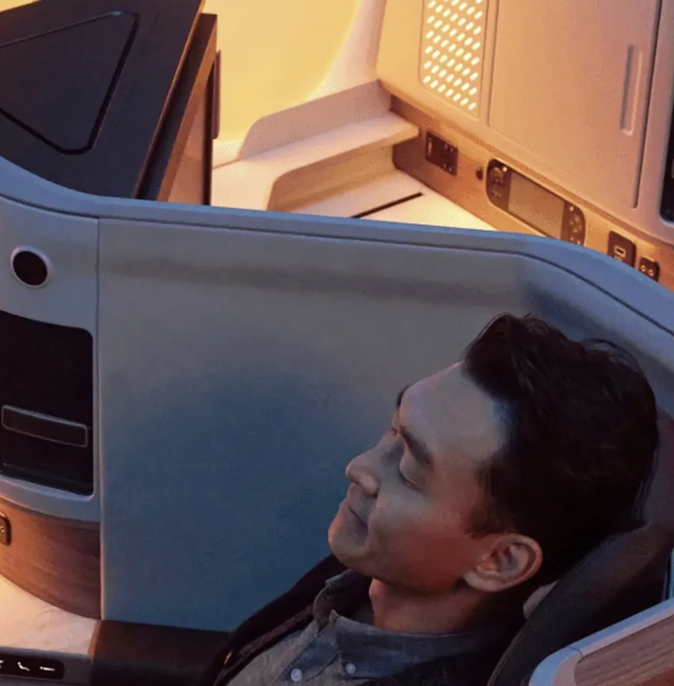 A man sitting in a seat on a plane.