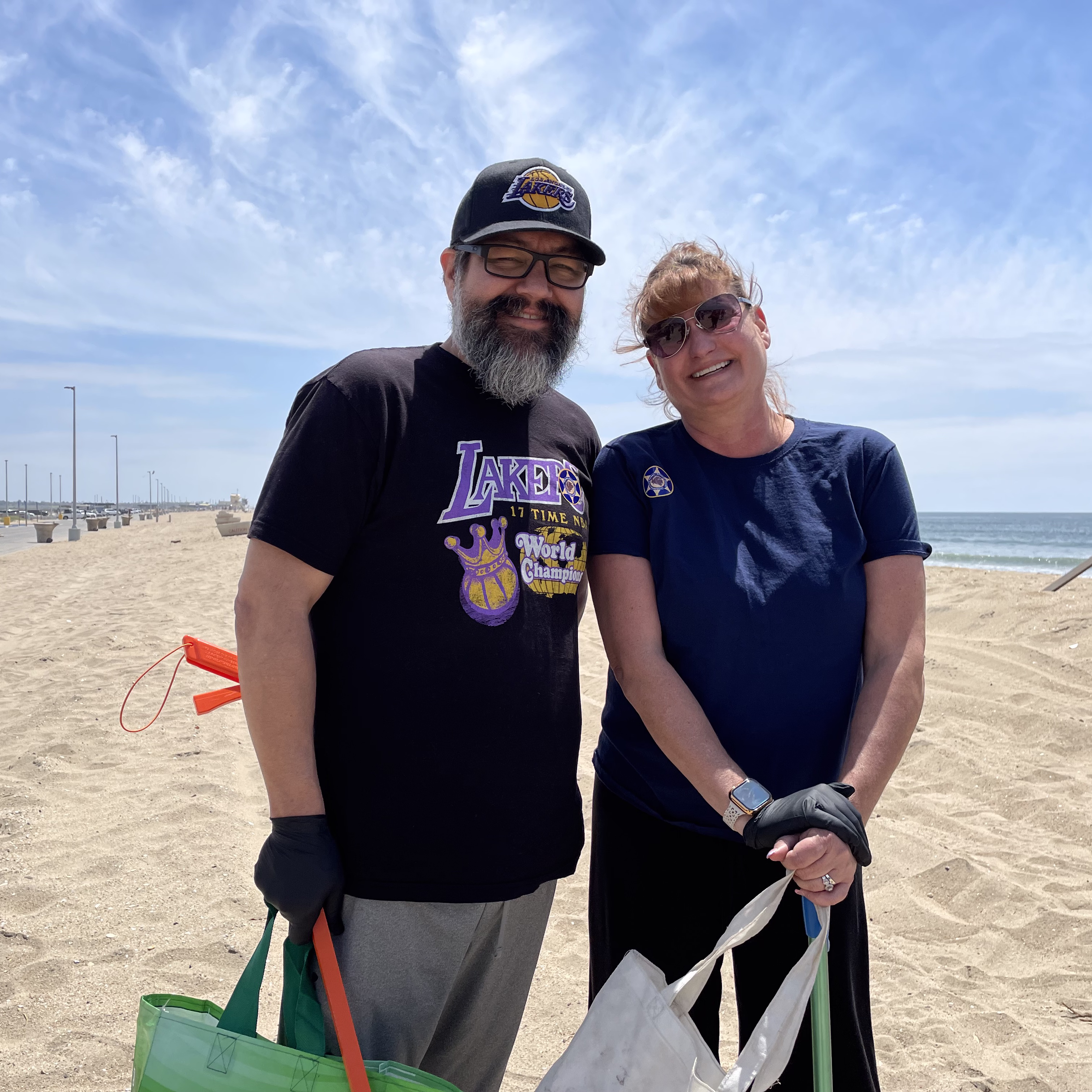 A man and a woman standing on a beach.