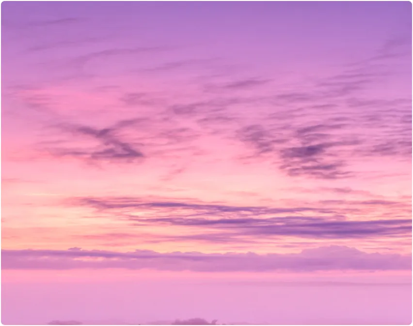 A pink and purple sky with some clouds.