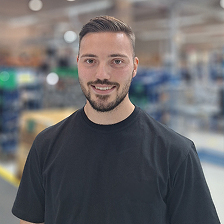 A man with a beard and a black shirt.