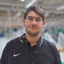 A man wearing glasses and a black shirt.