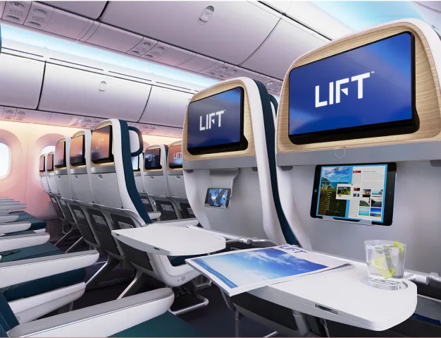 The interior of an airplane with a lot of seats.