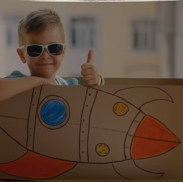 A young child lying on the floor focused on arranging colorful therapeutic stickers, demonstrating concentrated play-based learning activities