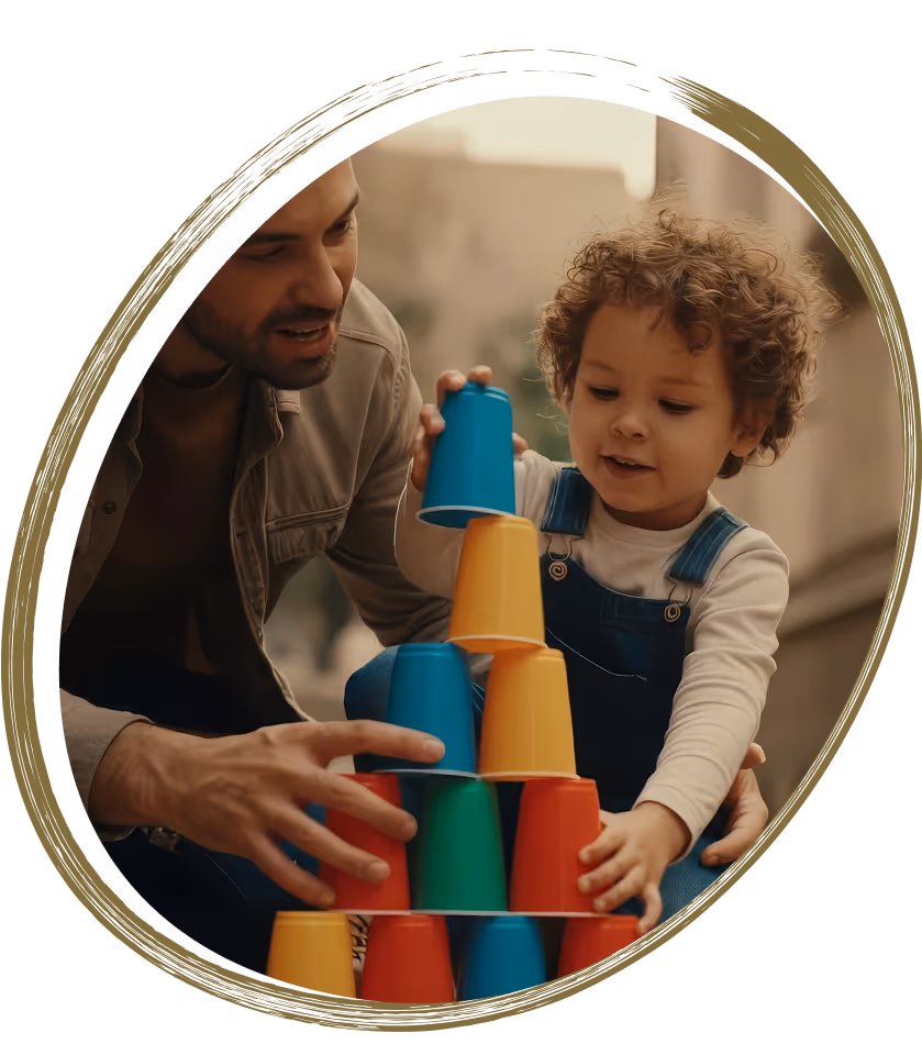 Father and child playing together, stacking colorful cups.